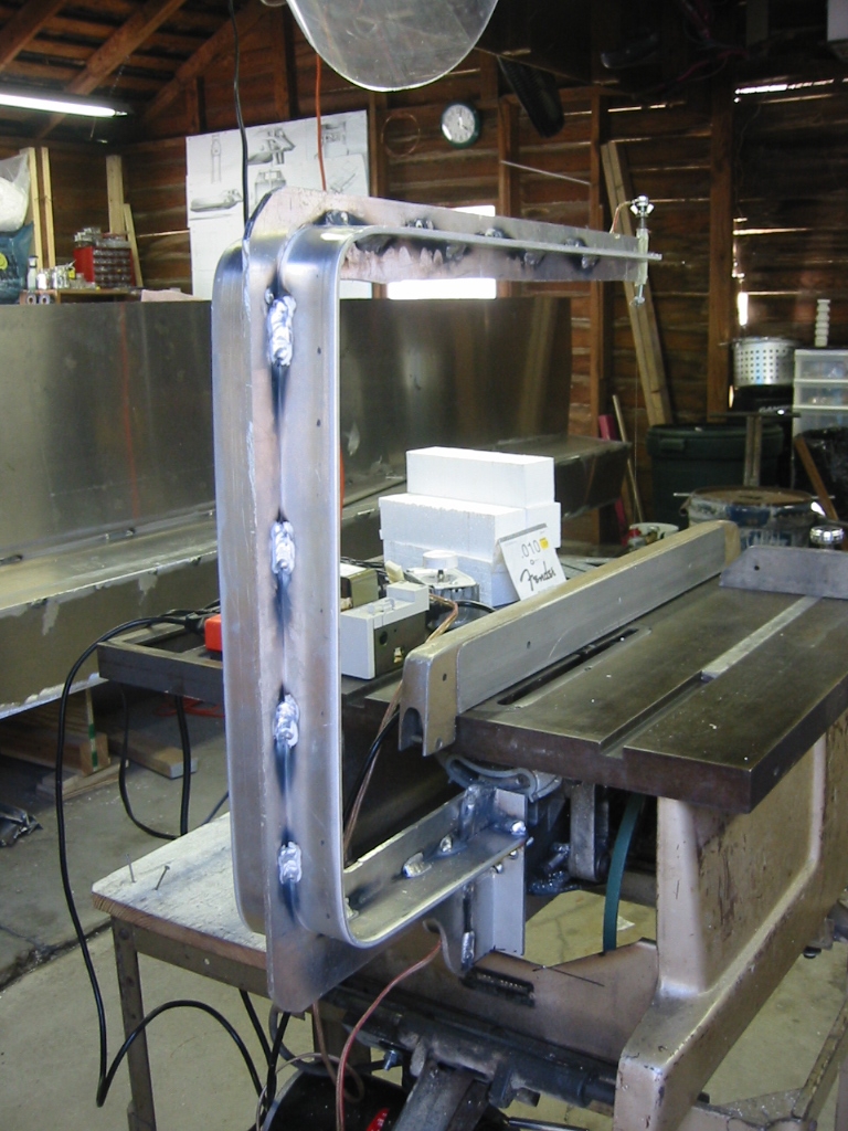 Aluminum arm is bolted onto the back of the blade spindle bracket.