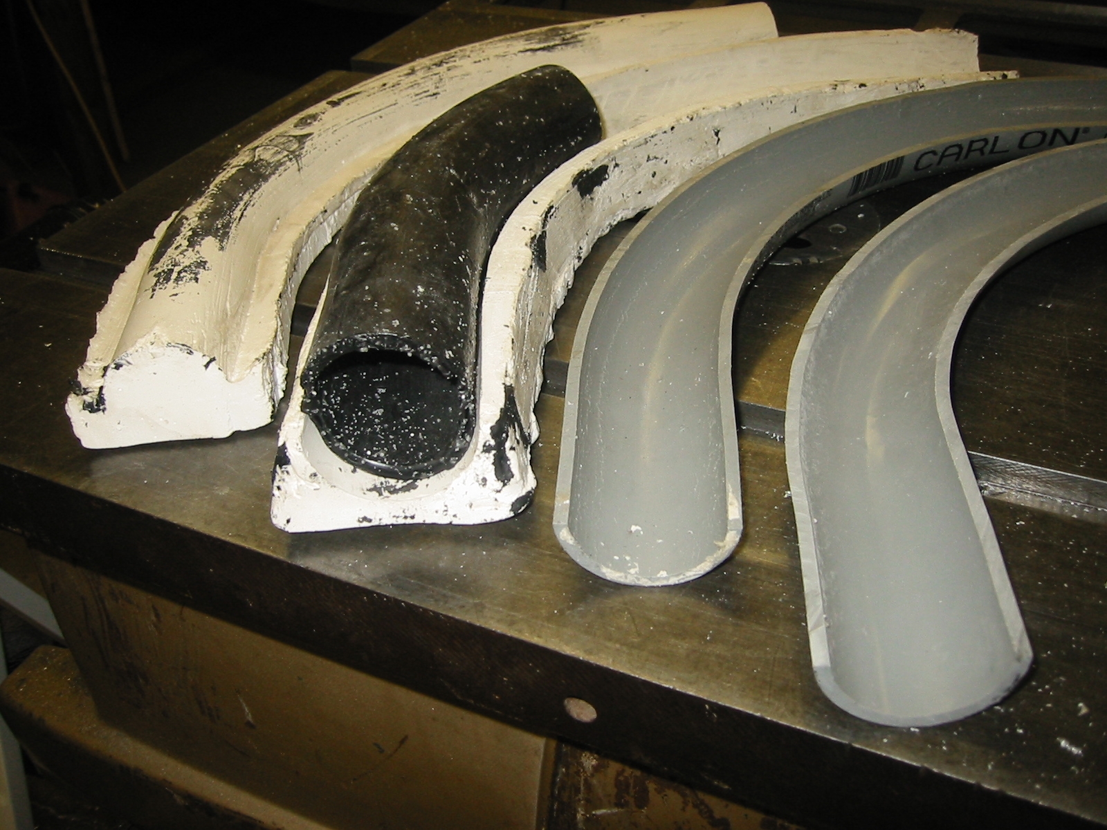 A machineable wax pipe made cast from a plaster cast that was cast from a half section of PVC conduit.