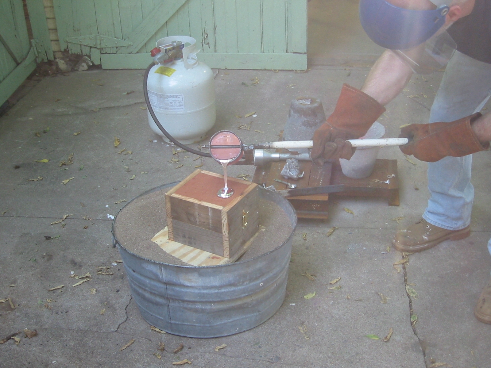 (15) Pour the flask with molten aluminum. Don't pour too slowly or the aluminum will harden too quickly in the gate, coking the part off.