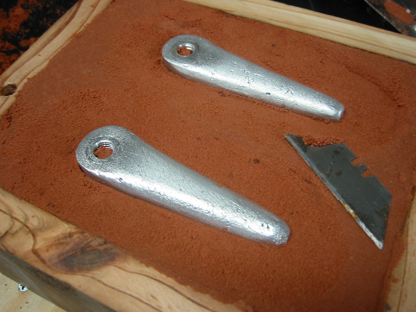 (5) Use a knife or blade to excavate the sand around the part/s just until you can safely lift the part from the sand without disturbing the remaining sand. This will be your