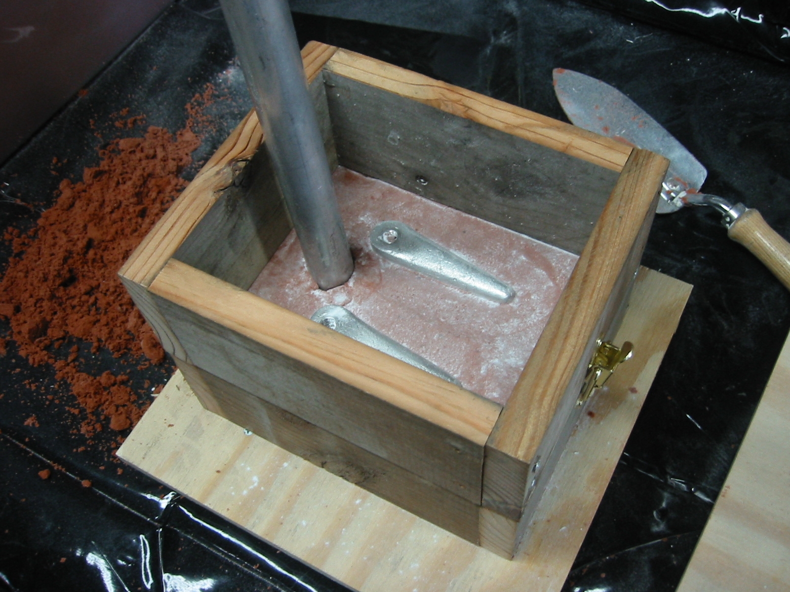 (7) Place the pipe back in place to from the sprue. Paper towel rollers work well if you don't have a piece of pipe. Then set on the top frame or the