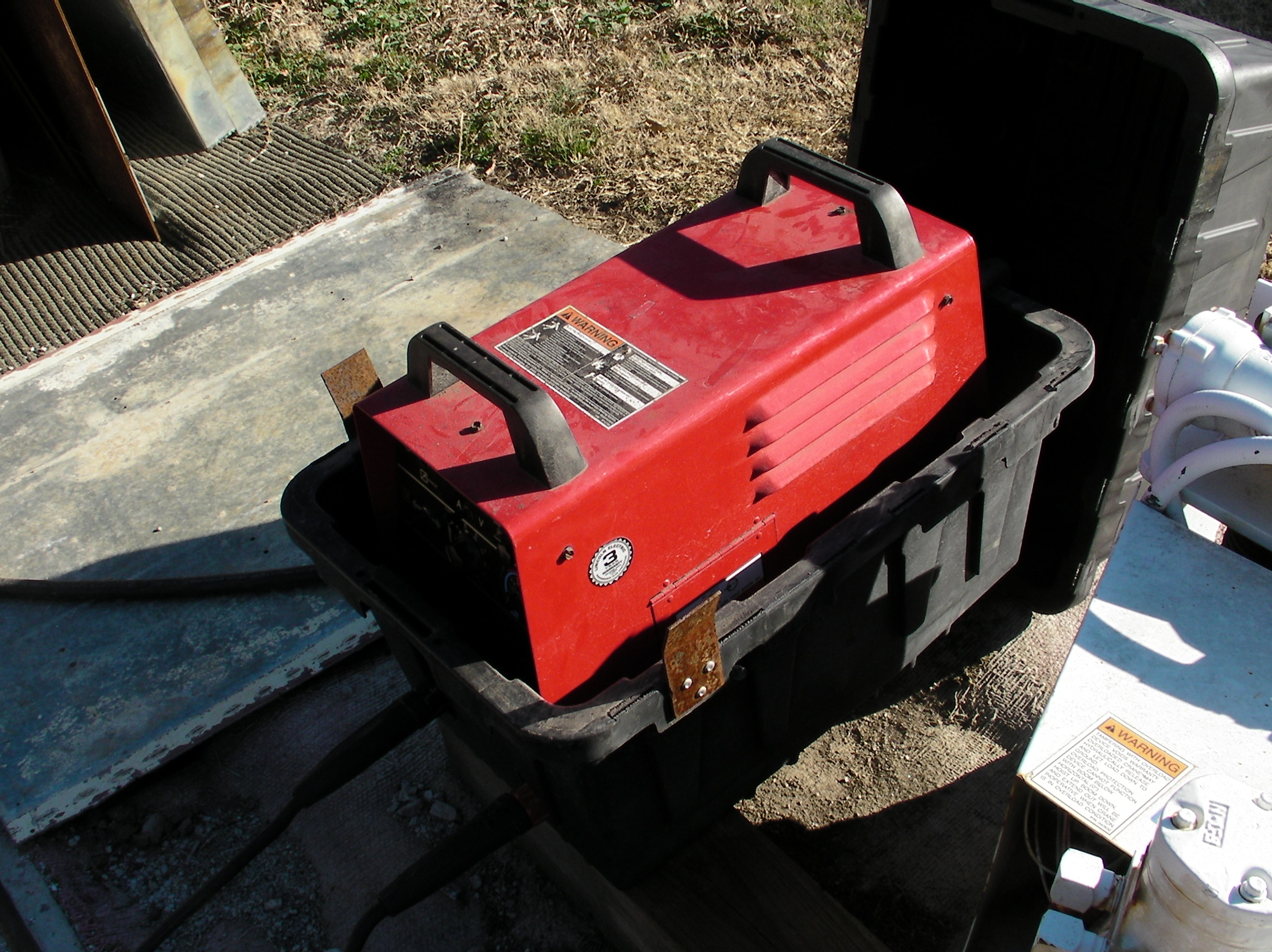 Lincoln Invertec V300-Pro in tote boxes for protection from the weather.