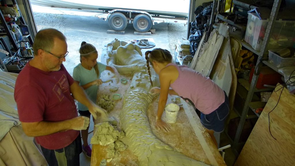 Alan and two helpers working on one of Seeker's mermaids in Shasta California.